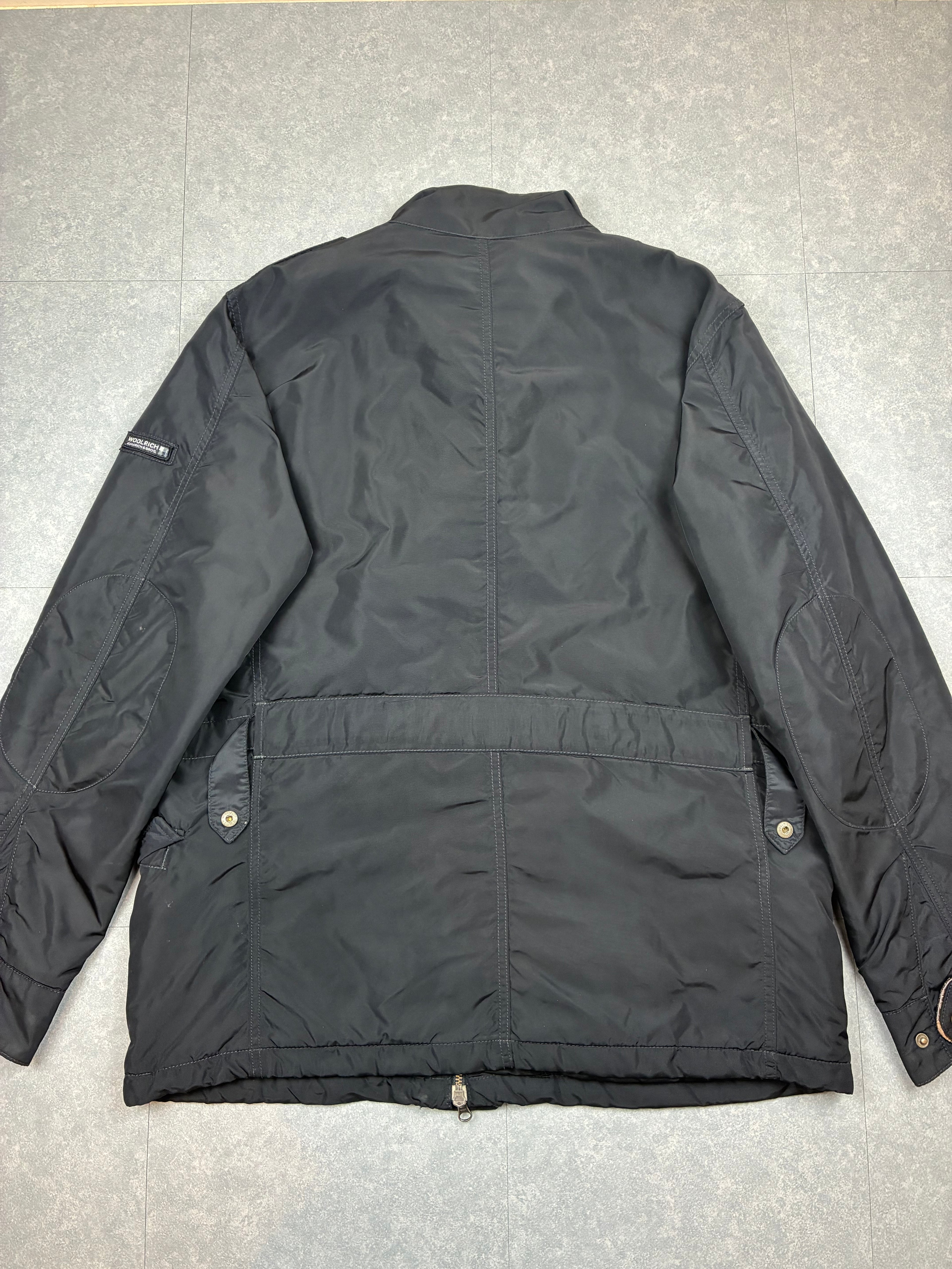 Woolrich John Rich & Bros — Giaccone tecnico Thermolite regolabile, colore nero.